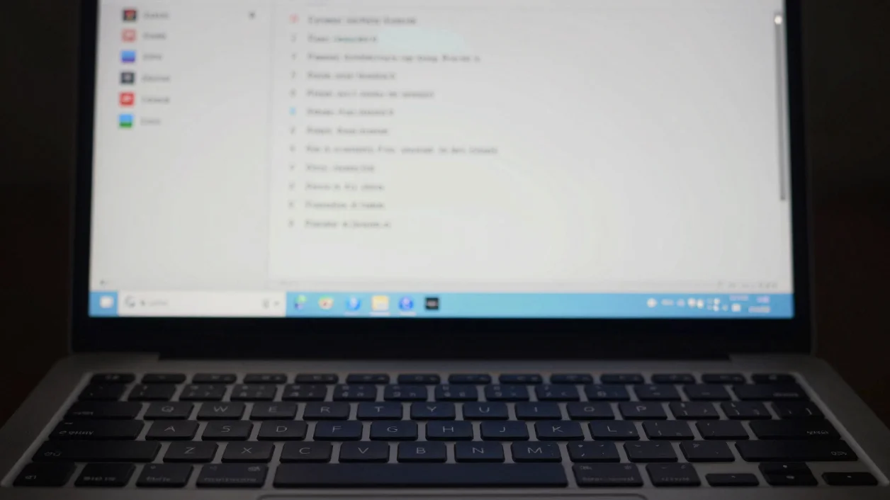 Close-up editorial photograph of a Windows laptop keyboard and sc